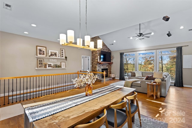 169 Rimmer Farm Rd, Troutman, NC 28166 - dining area with a ceiling fan, a fireplace, wood finished floors, high vaulted ceiling, and baseboards