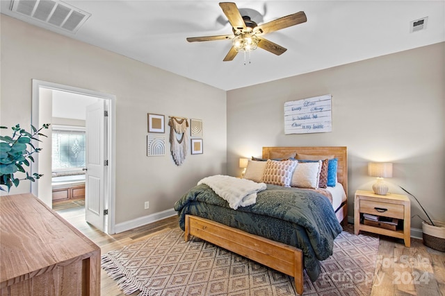169 Rimmer Farm Rd, Troutman, NC 28166 - bedroom with baseboards, light wood-style flooring, ensuite bathroom, and a ceiling fan