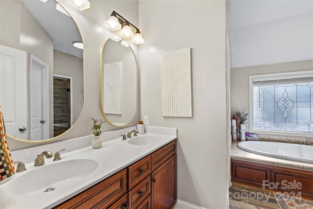 169 Rimmer Farm Rd, Troutman, NC 28166 - full bath with double vanity, a bathtub, baseboards, and wood finished floors