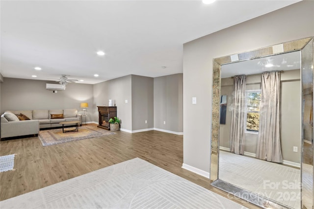 169 Rimmer Farm Rd, Troutman, NC 28166 - living room featuring wood finished floors, recessed lighting, a ceiling fan, baseboards, and a wall mounted air conditioner