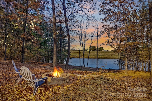 169 Rimmer Farm Rd, Troutman, NC 28166 - yard at dusk with a fire pit and a water view