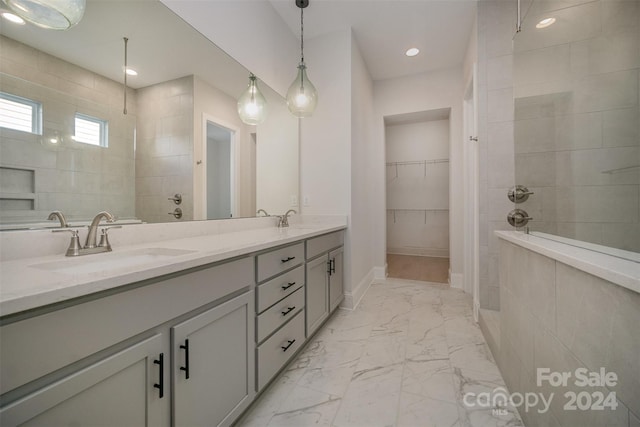 bathroom featuring vanity and tiled shower