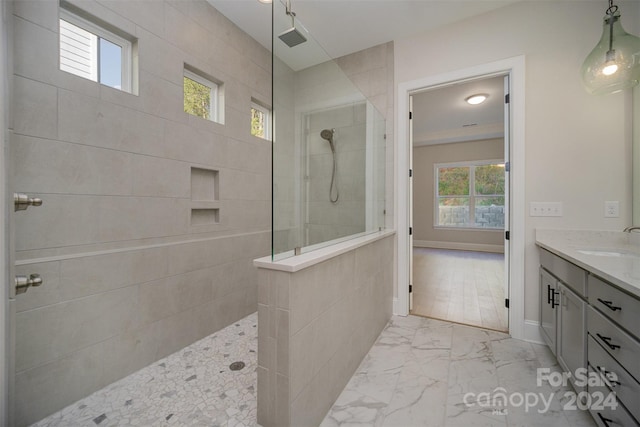 bathroom with vanity and tiled shower