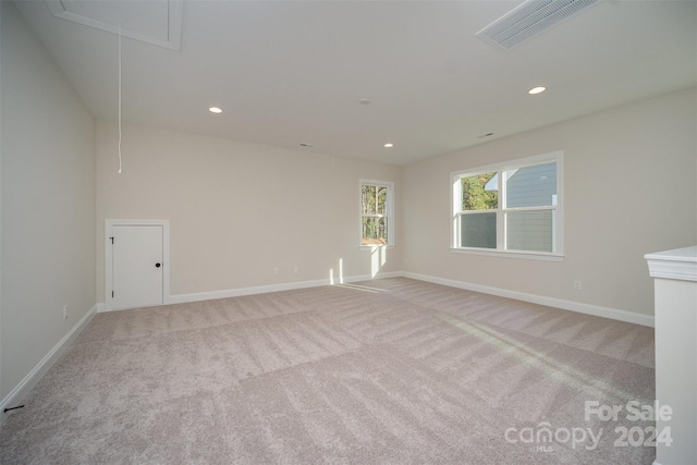 unfurnished room featuring light colored carpet