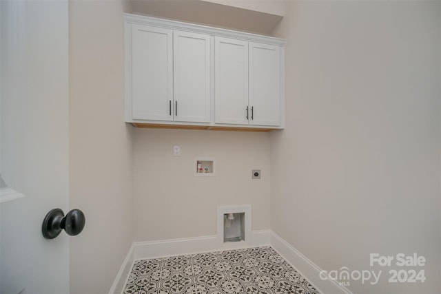 laundry area with cabinets, hookup for a washing machine, and hookup for an electric dryer