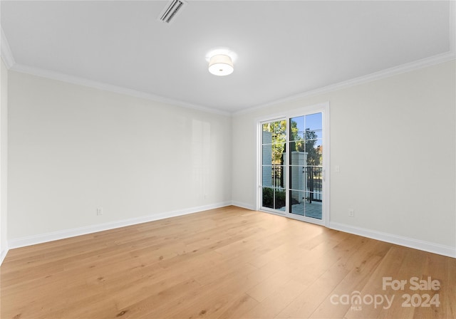 unfurnished room with light hardwood / wood-style flooring and ornamental molding