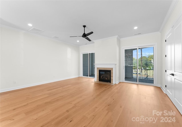 unfurnished living room with ceiling fan, light wood-type flooring, and ornamental molding