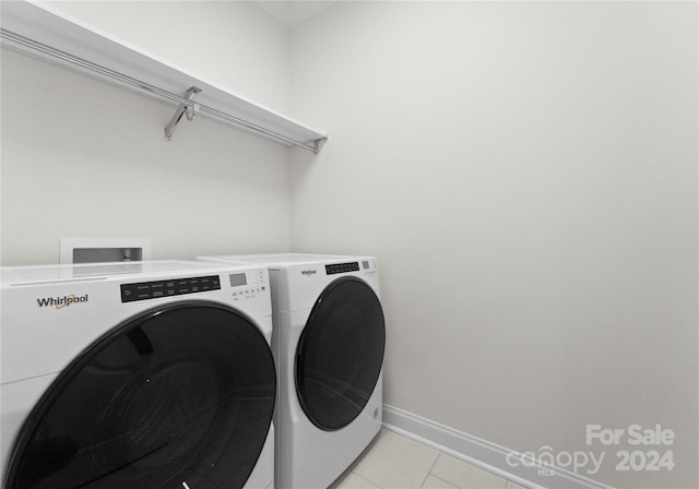 laundry room featuring washer and clothes dryer and light tile patterned flooring