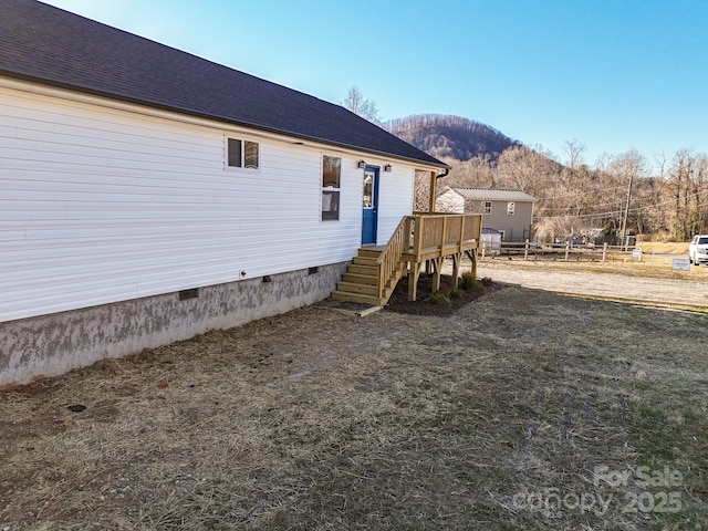 exterior space featuring a deck with mountain view