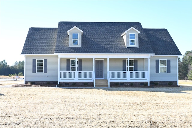 cape cod house featuring covered porch