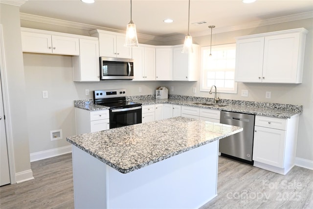 kitchen featuring white cabinets, appliances with stainless steel finishes, a center island, and sink