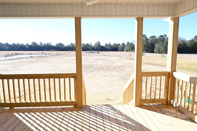 wooden deck with a rural view