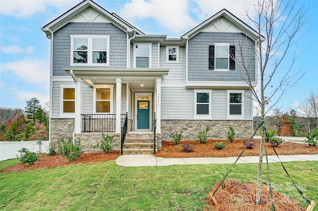 craftsman-style house featuring a front yard and covered porch