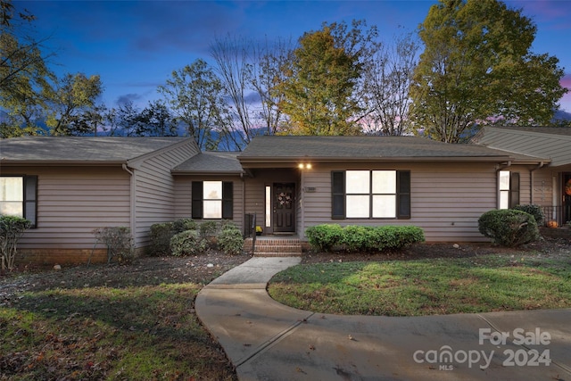 ranch-style home featuring a yard