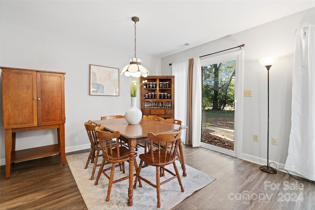 dining room with dark hardwood / wood-style flooring