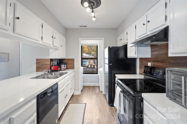 kitchen with white cabinetry, sink, black appliances, and light hardwood / wood-style floors