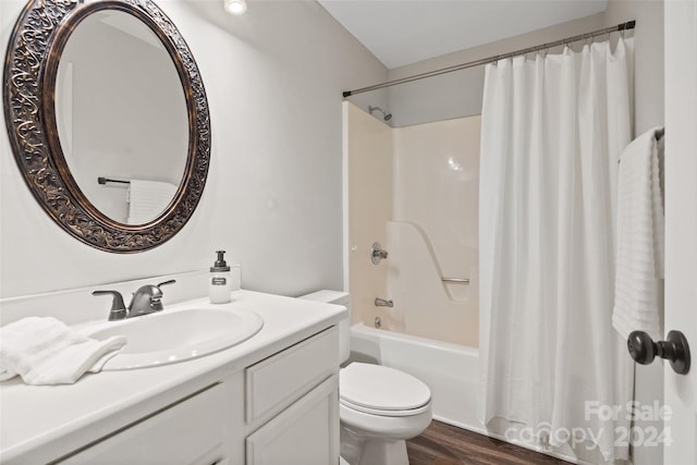 full bathroom featuring vanity, hardwood / wood-style floors, shower / bathtub combination with curtain, and toilet