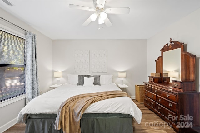 bedroom featuring dark hardwood / wood-style flooring and ceiling fan