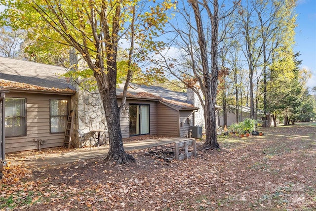 view of side of home with a patio area and central air condition unit