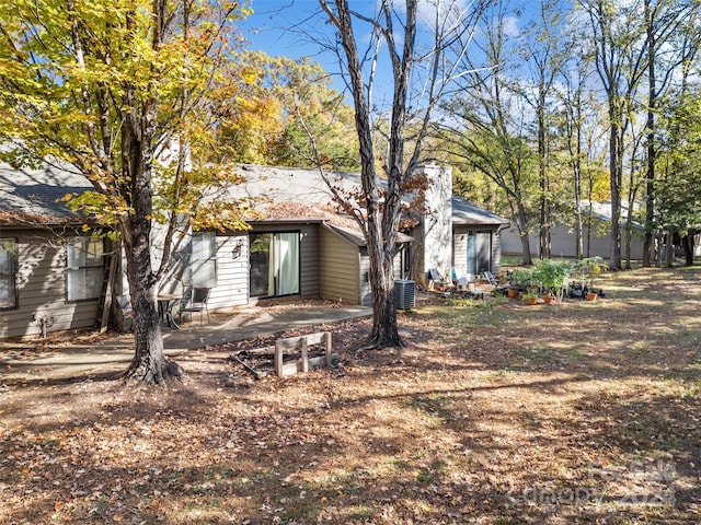 rear view of house featuring a patio area and central AC