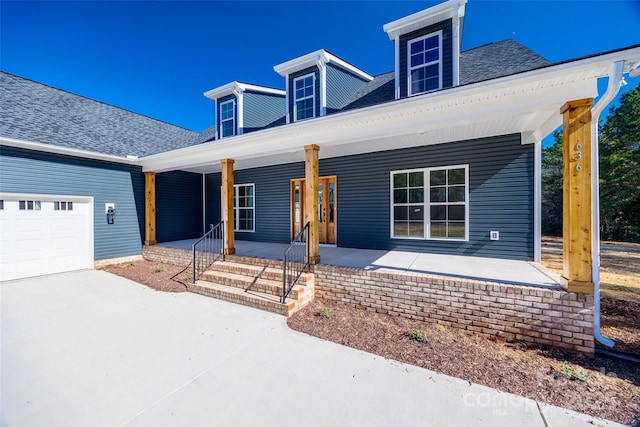 view of front of home with a garage and covered porch