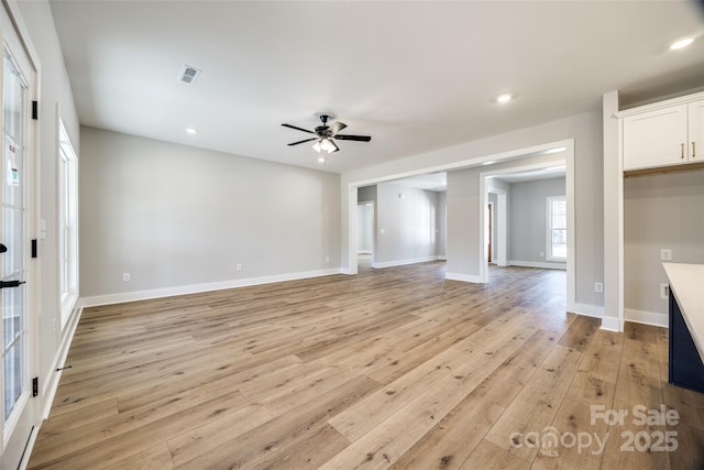 unfurnished living room featuring ceiling fan and light hardwood / wood-style floors