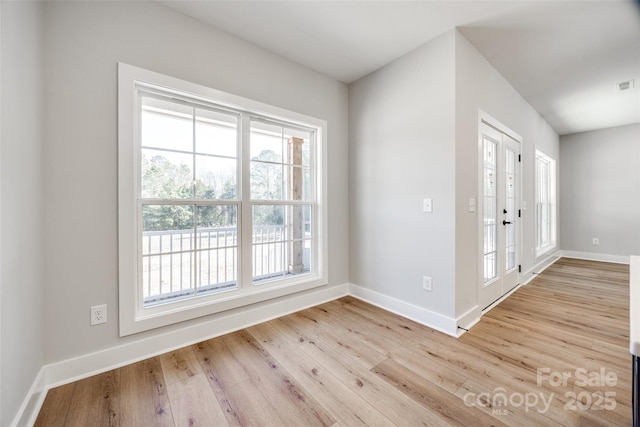 entryway with french doors and light wood-type flooring