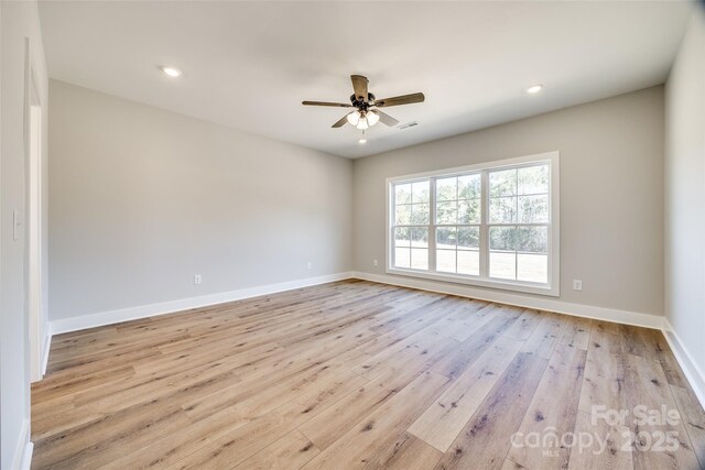 unfurnished room featuring ceiling fan and light wood-type flooring