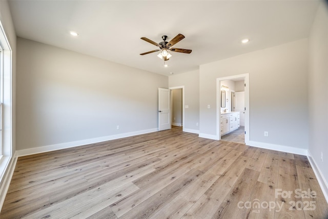 unfurnished bedroom featuring ensuite bathroom, ceiling fan, and light wood-type flooring