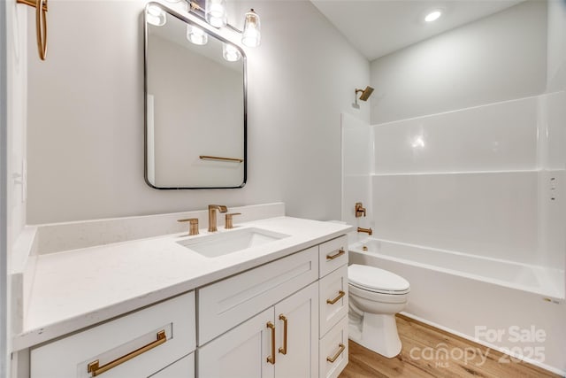 full bathroom featuring vanity, shower / bathing tub combination, toilet, and hardwood / wood-style flooring