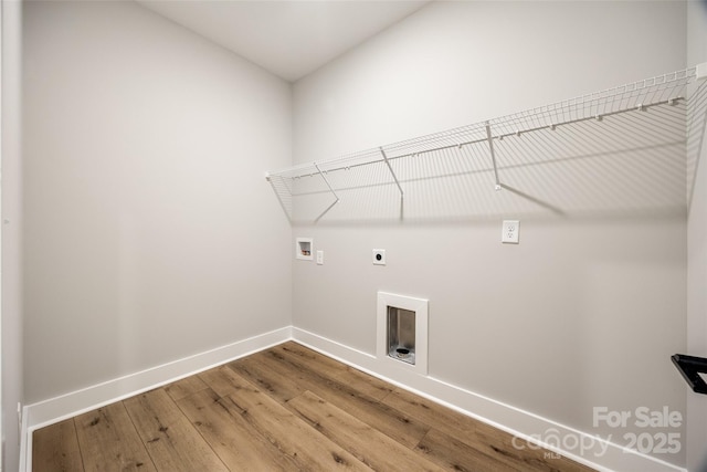 washroom with hookup for a washing machine, wood-type flooring, and electric dryer hookup