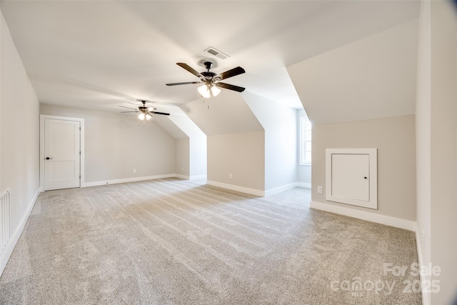 additional living space with lofted ceiling, light colored carpet, and ceiling fan