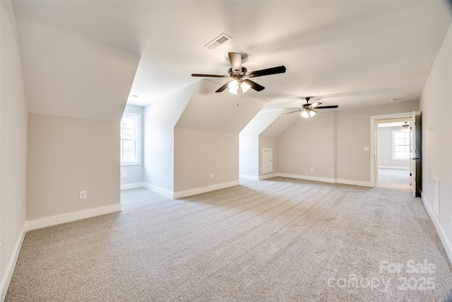 additional living space with lofted ceiling, light colored carpet, and ceiling fan