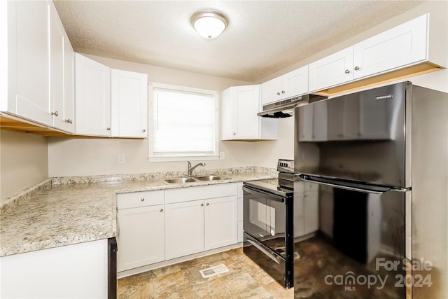 kitchen with black electric range, stainless steel fridge, white cabinets, and sink