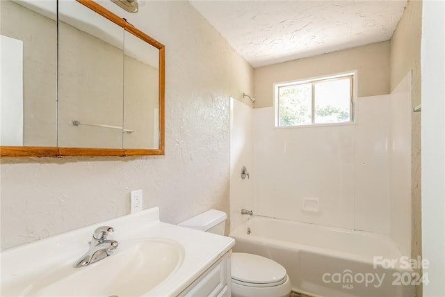 full bathroom with bathing tub / shower combination, vanity, toilet, and a textured ceiling