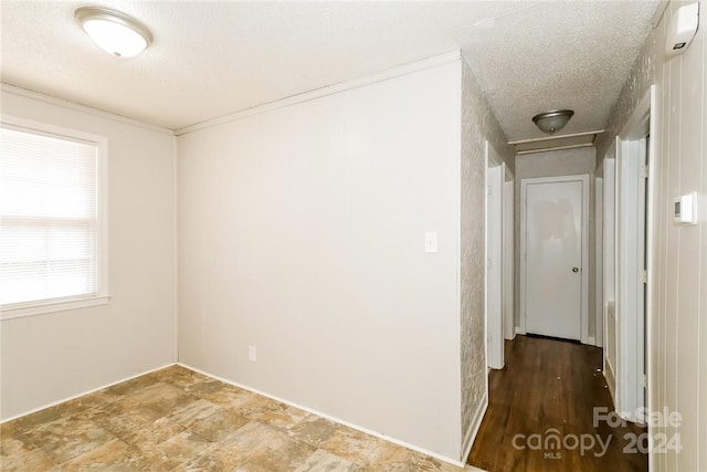 hall featuring a textured ceiling