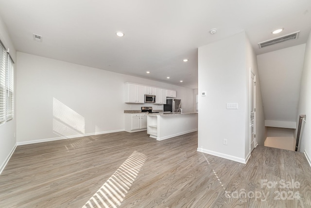 unfurnished living room with light wood-type flooring