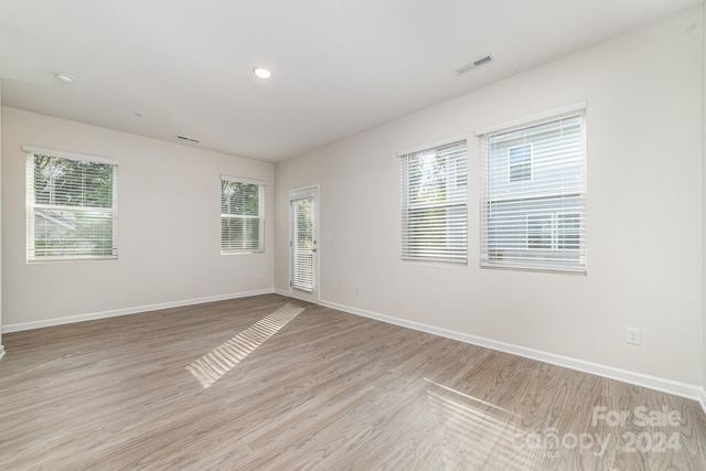 spare room with light hardwood / wood-style flooring