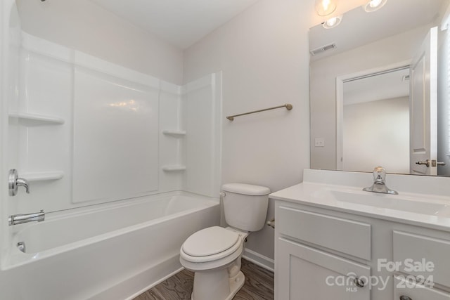 full bathroom with vanity, hardwood / wood-style flooring, toilet, and shower / washtub combination