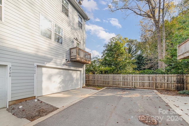 view of patio / terrace with a balcony and a garage