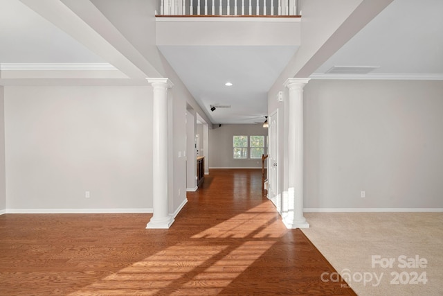 foyer entrance with wood-type flooring, ceiling fan, and ornamental molding