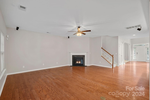 unfurnished living room featuring light hardwood / wood-style flooring and ceiling fan