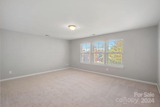 unfurnished room with light colored carpet