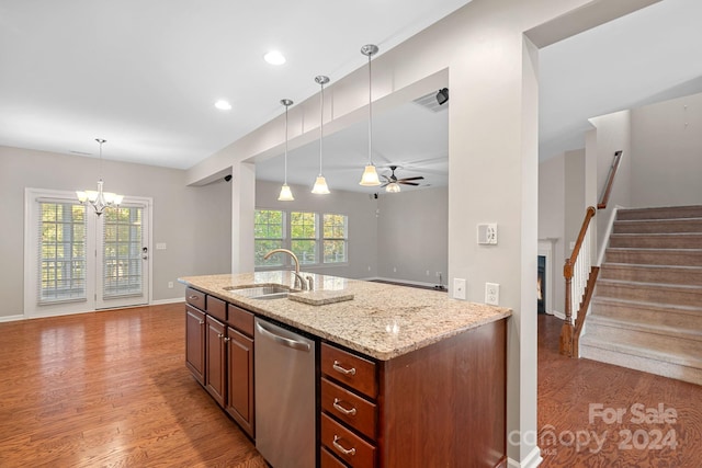 kitchen featuring dishwasher, ceiling fan with notable chandelier, sink, light stone countertops, and light wood-type flooring