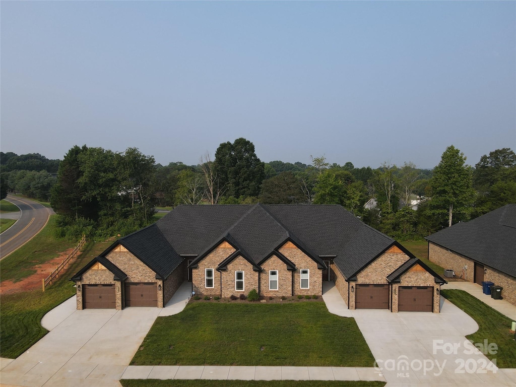 view of front of property featuring a garage and a front lawn