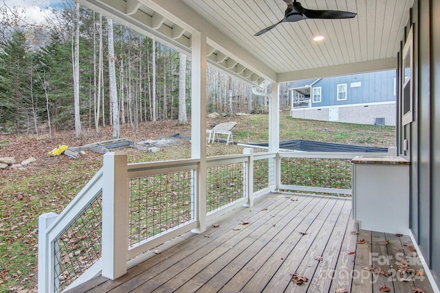 unfurnished sunroom featuring ceiling fan, plenty of natural light, and wood ceiling