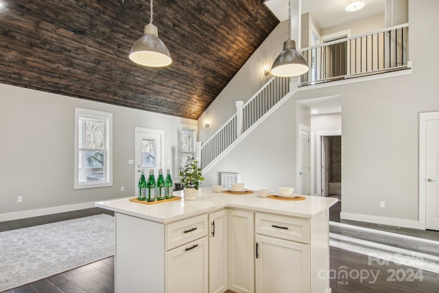 kitchen with decorative light fixtures, a center island, wooden ceiling, and dark wood-type flooring