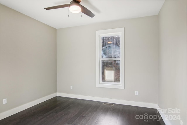 unfurnished room featuring ceiling fan and dark hardwood / wood-style flooring