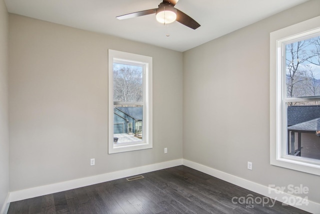 unfurnished room featuring dark hardwood / wood-style floors and ceiling fan