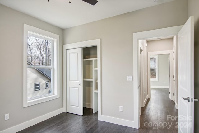 unfurnished bedroom featuring ceiling fan, a closet, and dark hardwood / wood-style floors